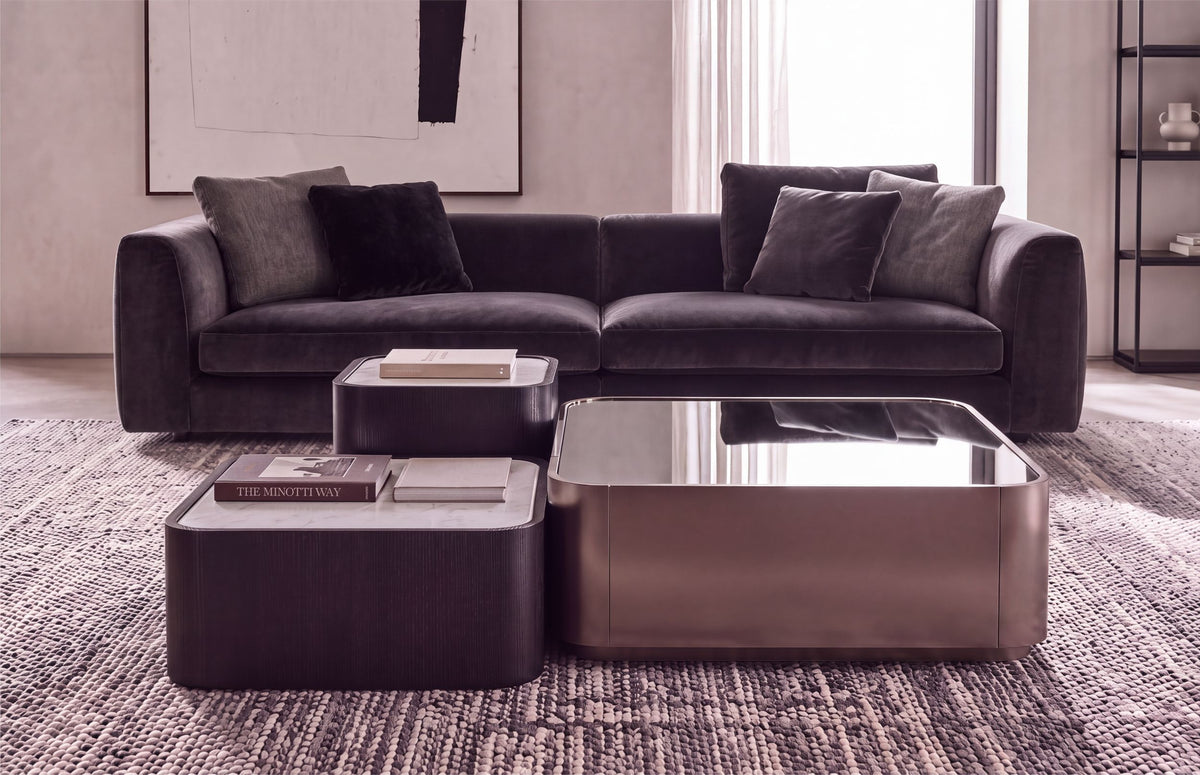 AXE coffee tables in front of a velvet sofa