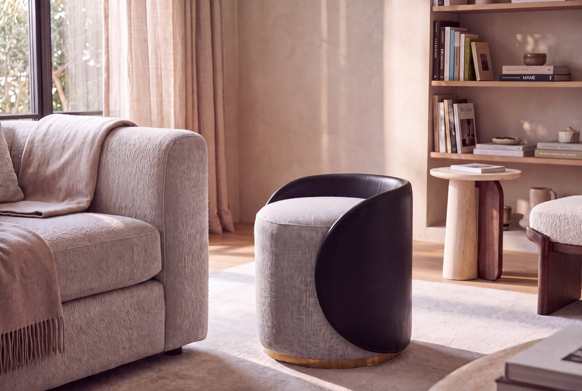 Moby pouf in grey fabric and black leather in a living room